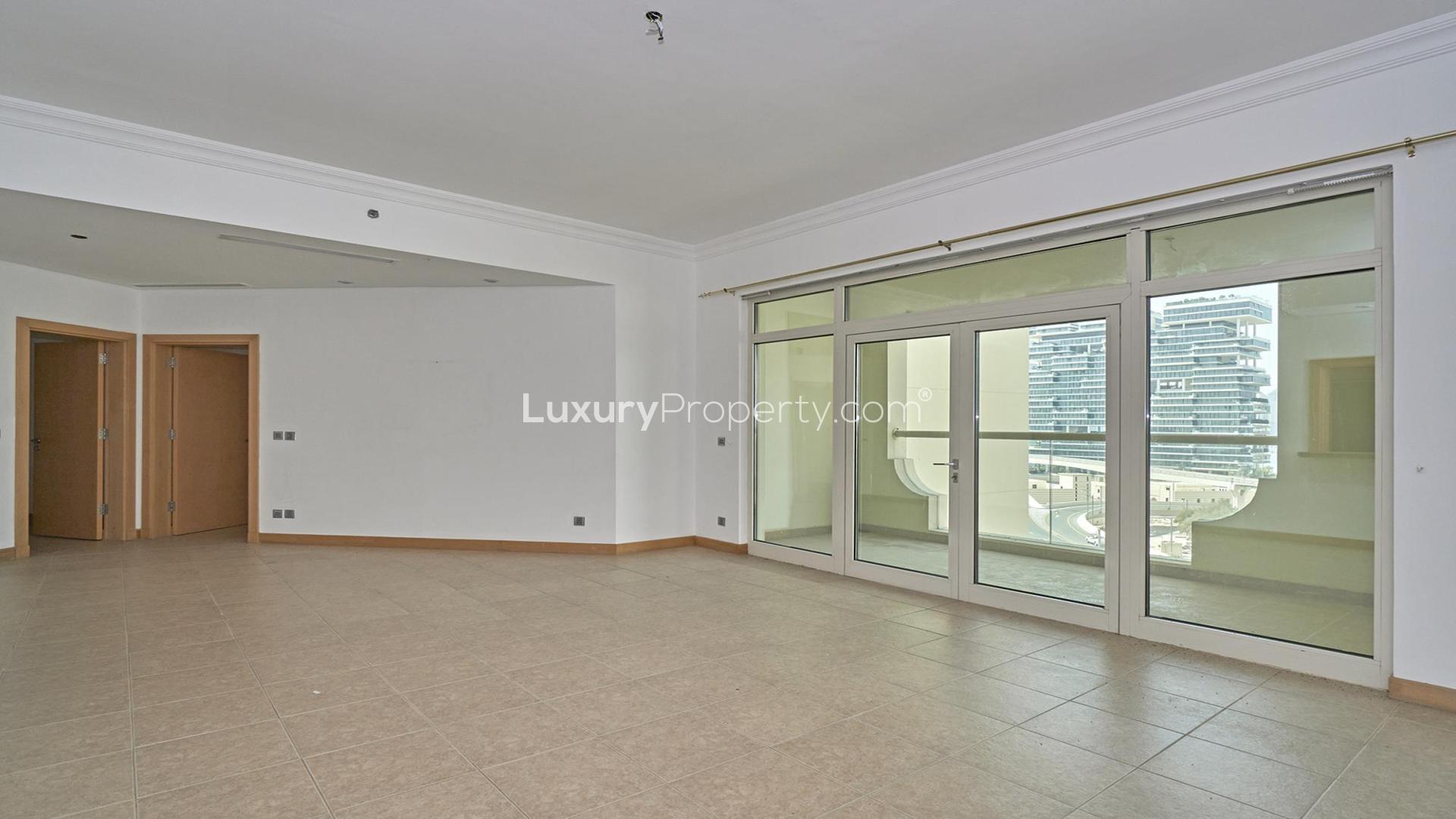 Spacious living room in Palm Jumeirah Shoreline Apartments for rent, featuring large windows