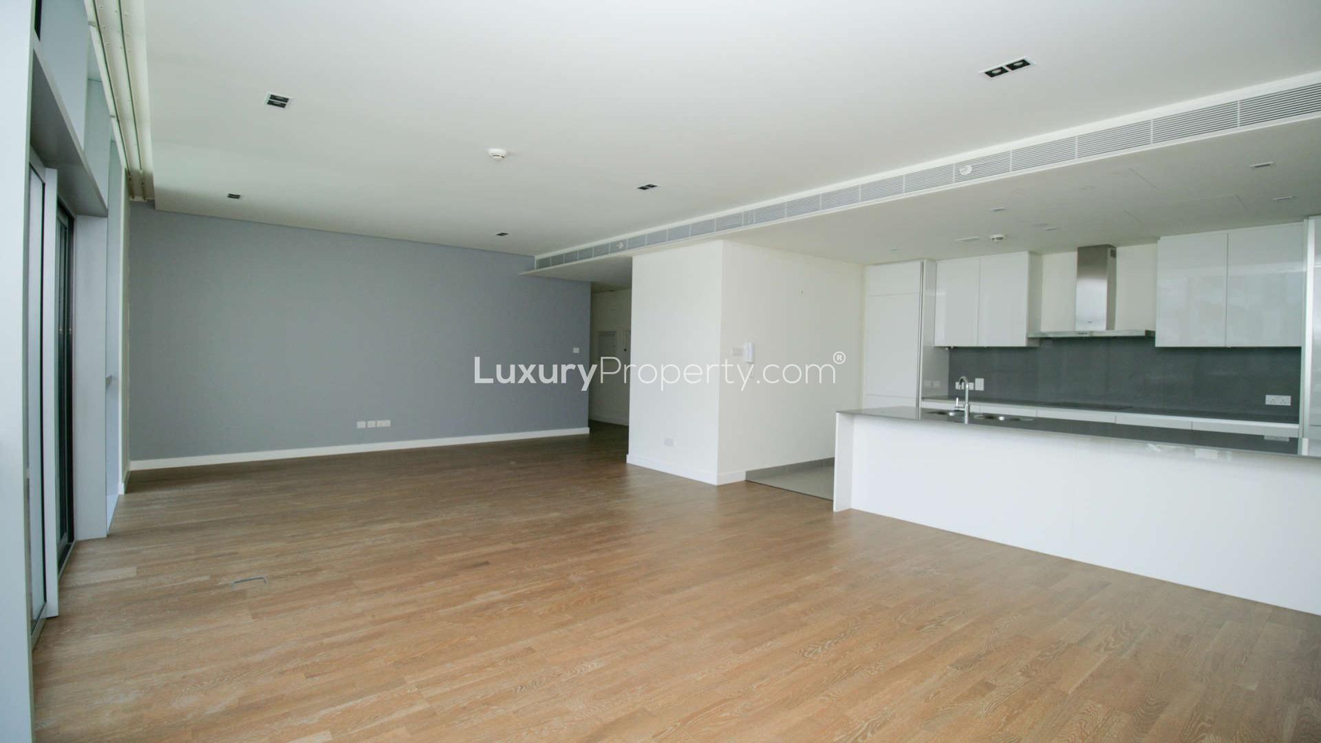 Spacious living room with hardwood floors and large windows in City Walk apartment for rent