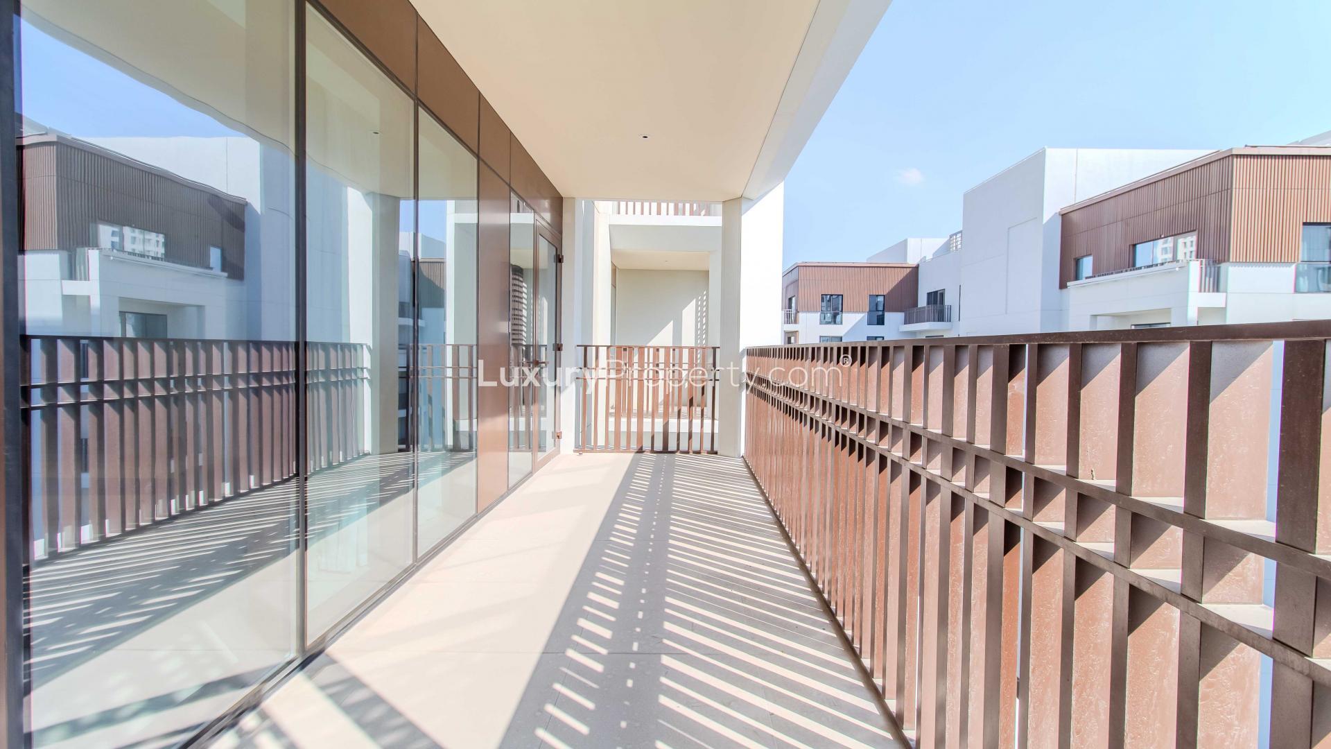 Furnished living area in Dubai Creek Harbour apartment with modern kitchen and dining space