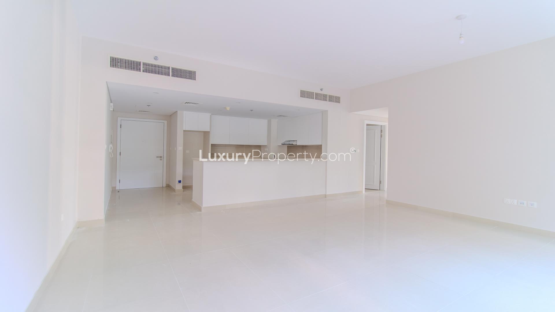 "Spacious garden view of two-bedroom apartment in Harbour Views 2, Dubai Creek Harbour.",Spacious open-plan kitchen and living area in Dubai Creek Harbour apartment for rent
