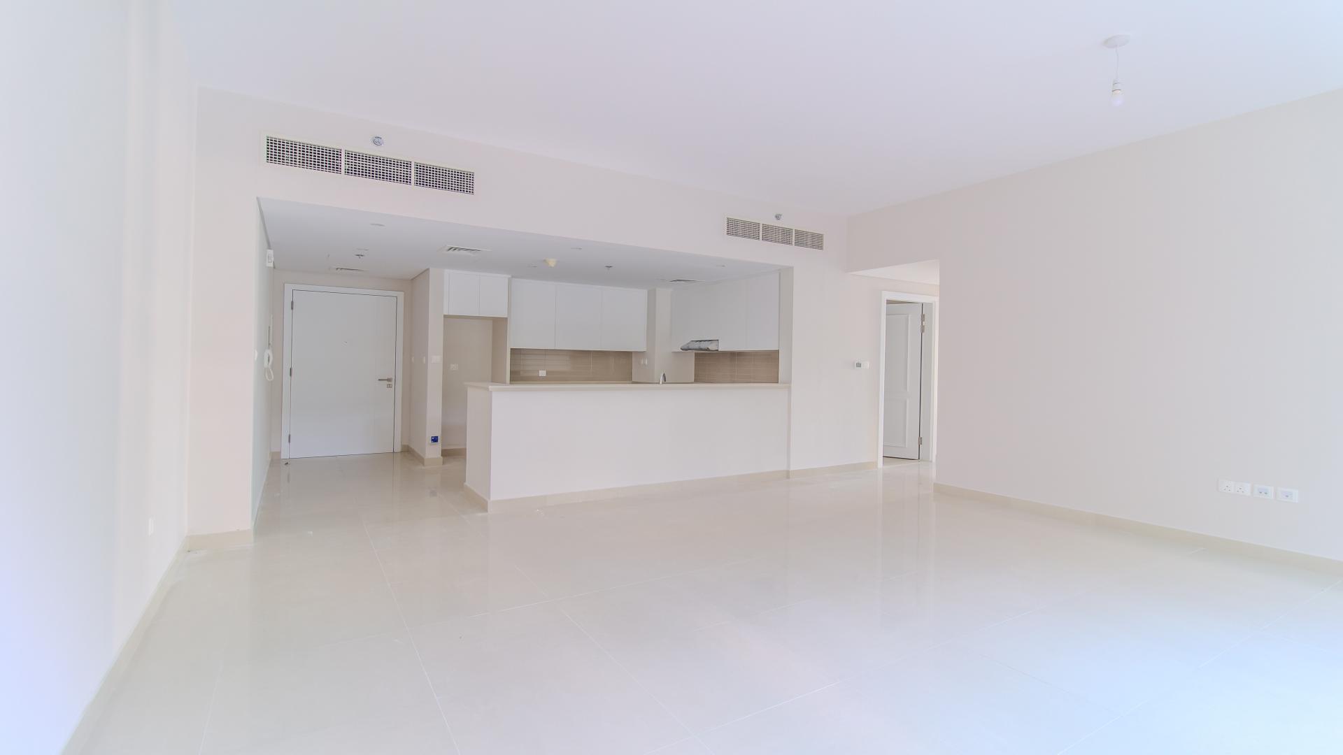 "Spacious garden view of two-bedroom apartment in Harbour Views 2, Dubai Creek Harbour.",Spacious open-plan kitchen and living area in Dubai Creek Harbour apartment for rent