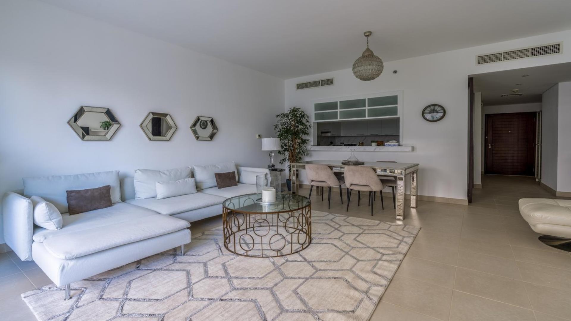 Elegant living room in Downtown Dubai apartment, Boulevard Central Towers, with modern decor and balcony