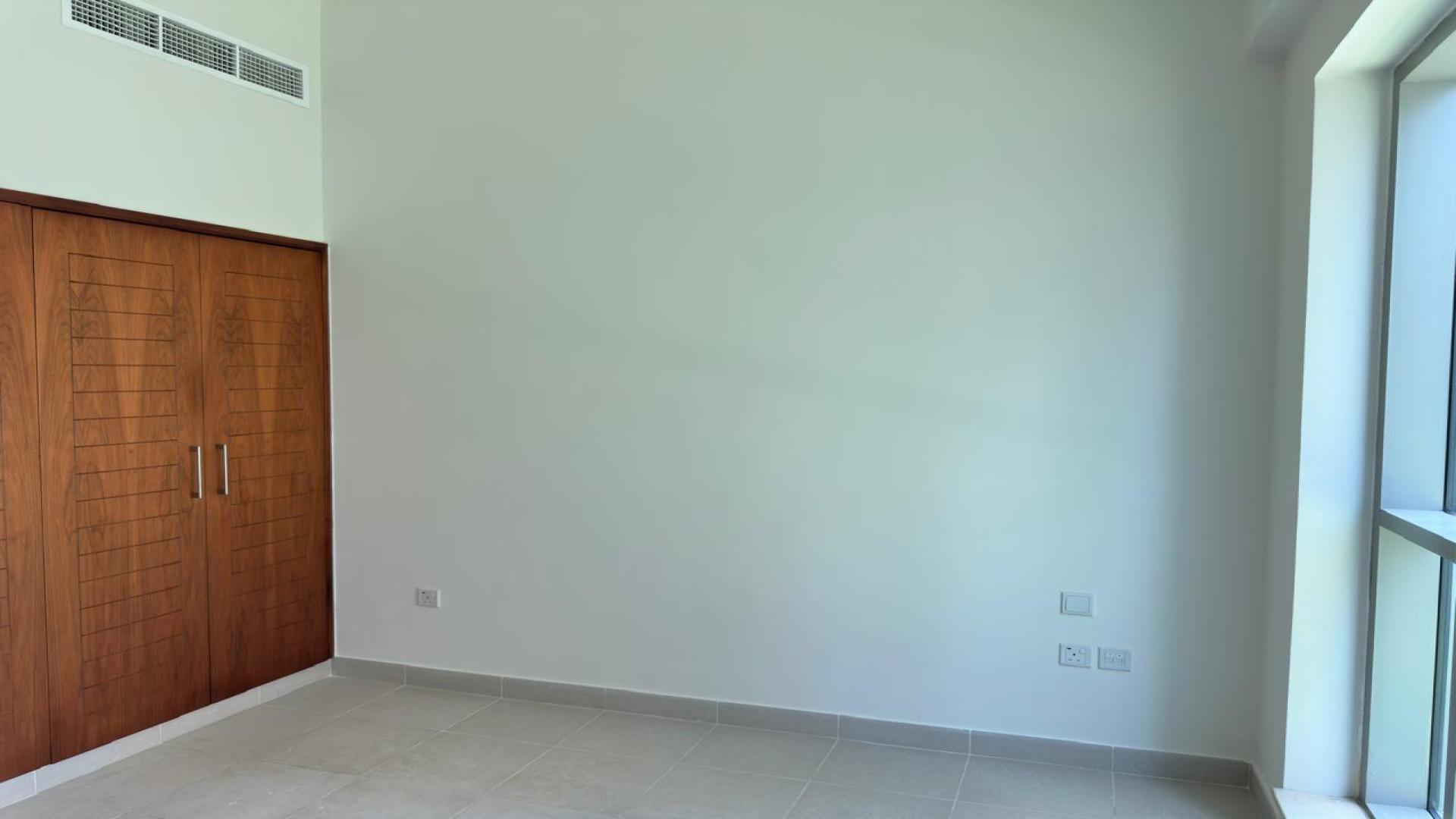 Empty bedroom with built-in wooden closets in Boulevard Central Tower 2, Downtown Dubai