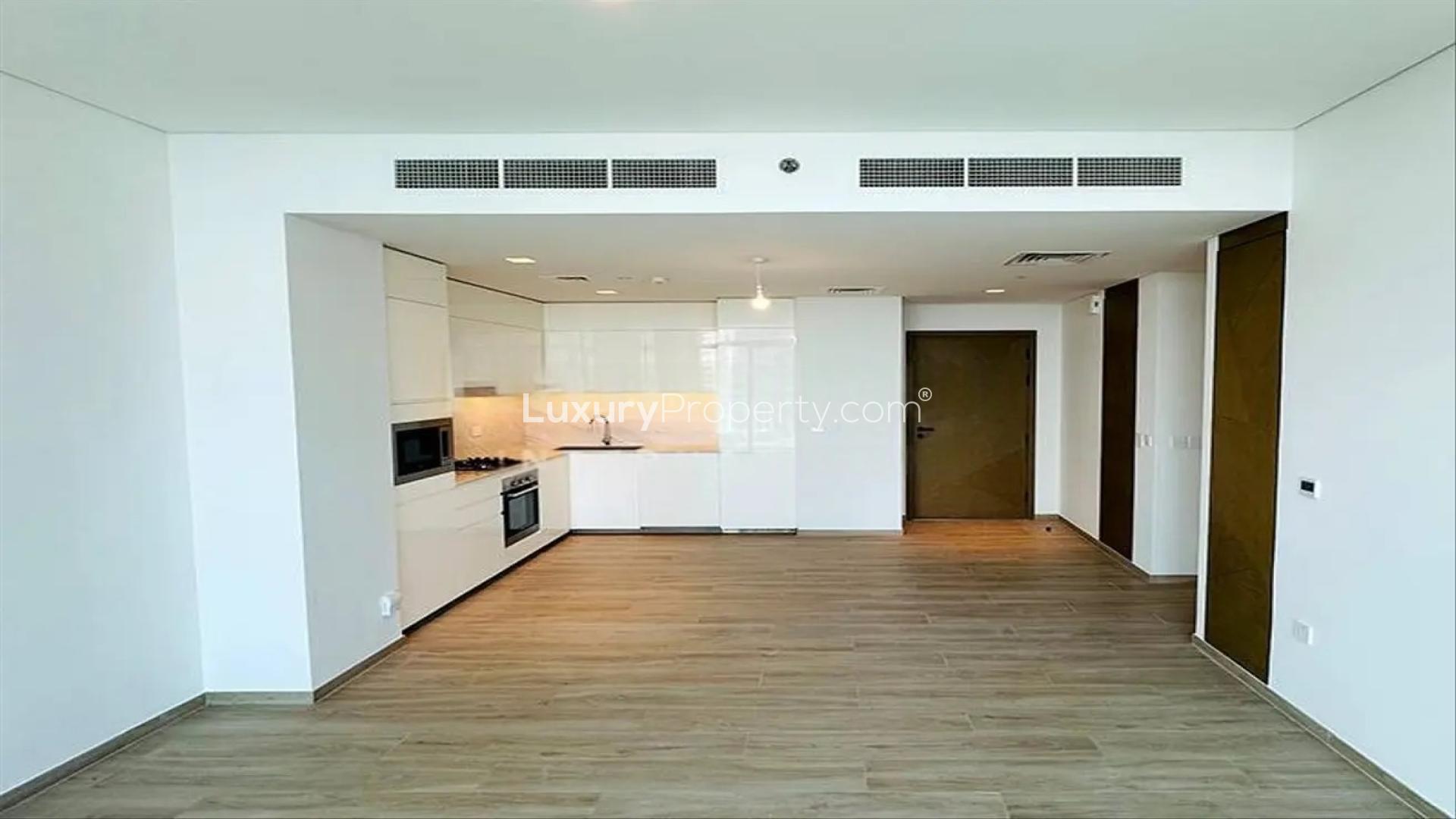 "High-floor apartment balcony view overlooking Dubai Creek Harbour waterfront, Palace Residences.",Modern kitchen in high-floor apartment, Dubai Creek Harbour, Palace Residences, chiller free rental