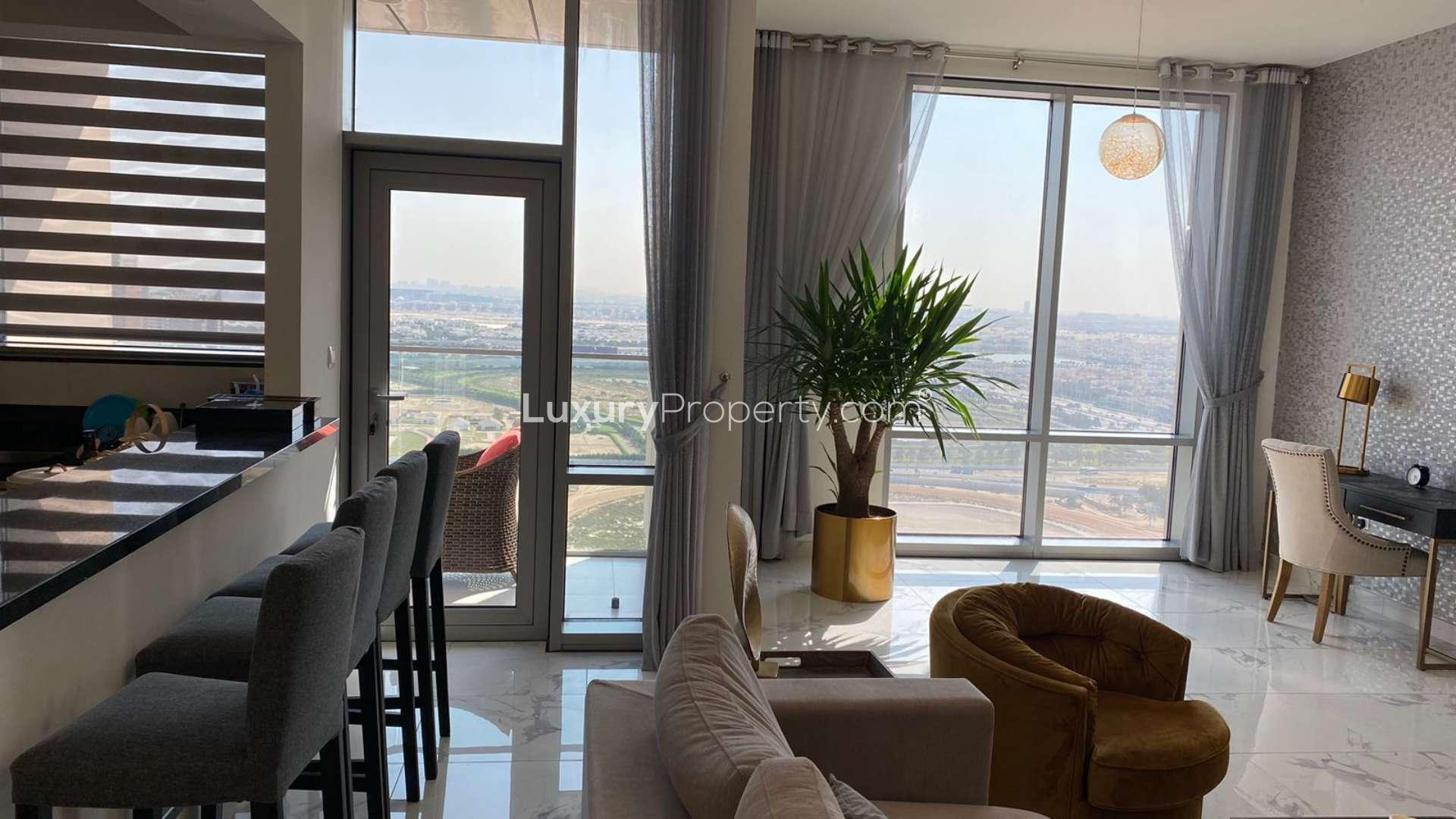 Modern living room in Al Habtoor City apartment, featuring large windows and stylish decor