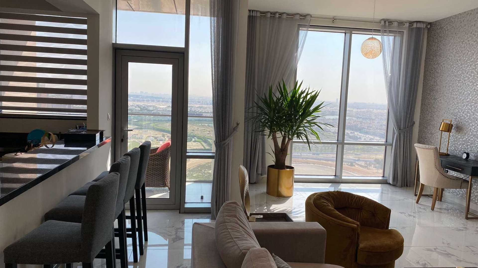 Modern living room in Al Habtoor City apartment, featuring large windows and stylish decor