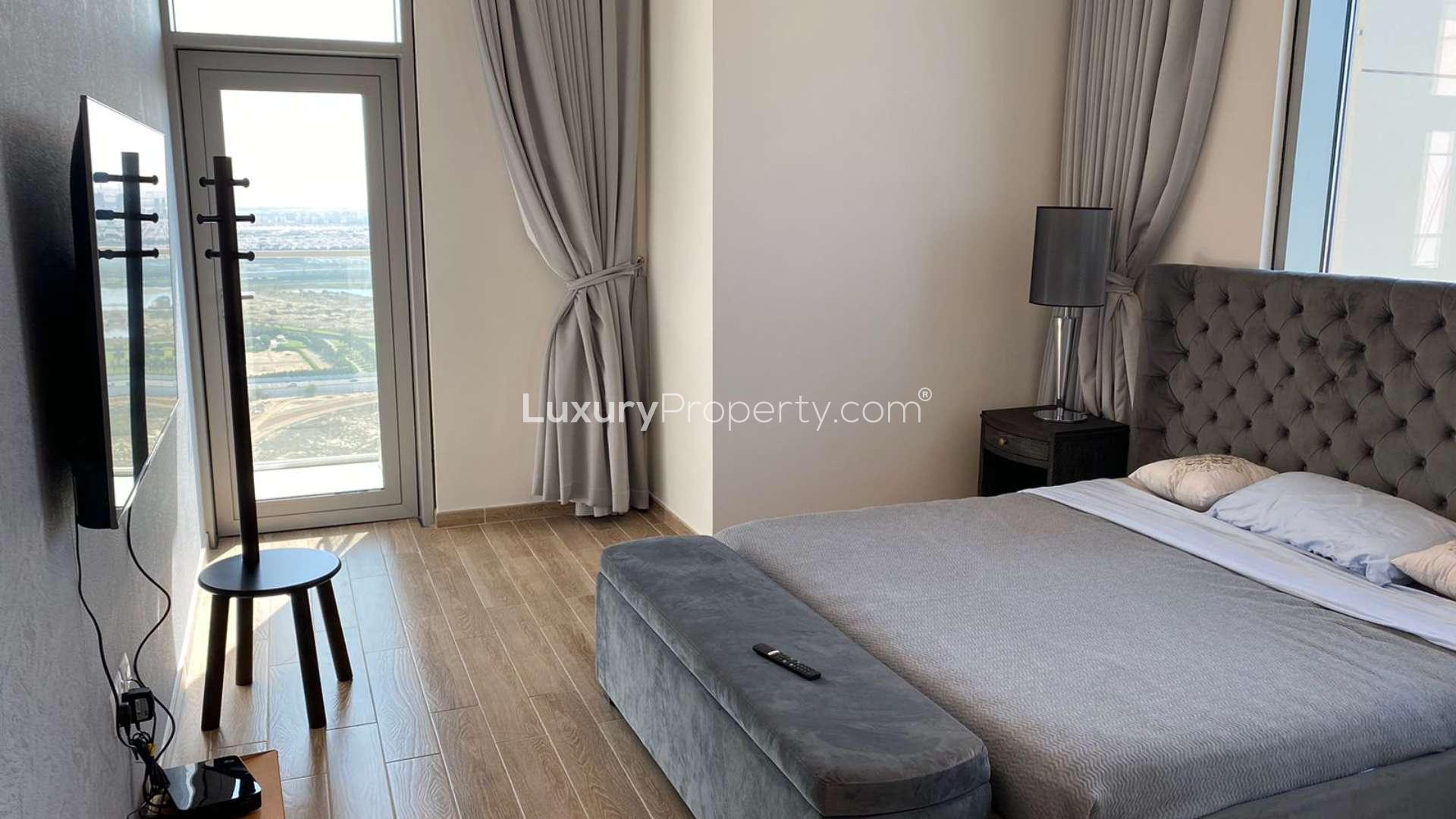 Modern living room in Business Bay apartment with stylish decor and open kitchen layout