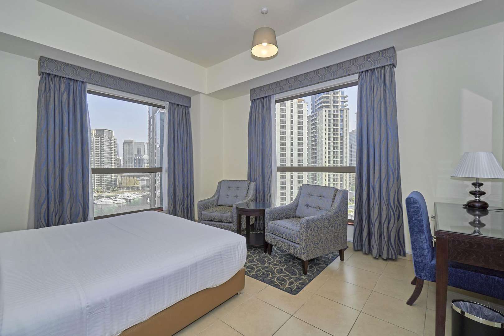 Living room in 2-bedroom apartment, Roda Amwaj Towers, JBR, with blue sofa and TV