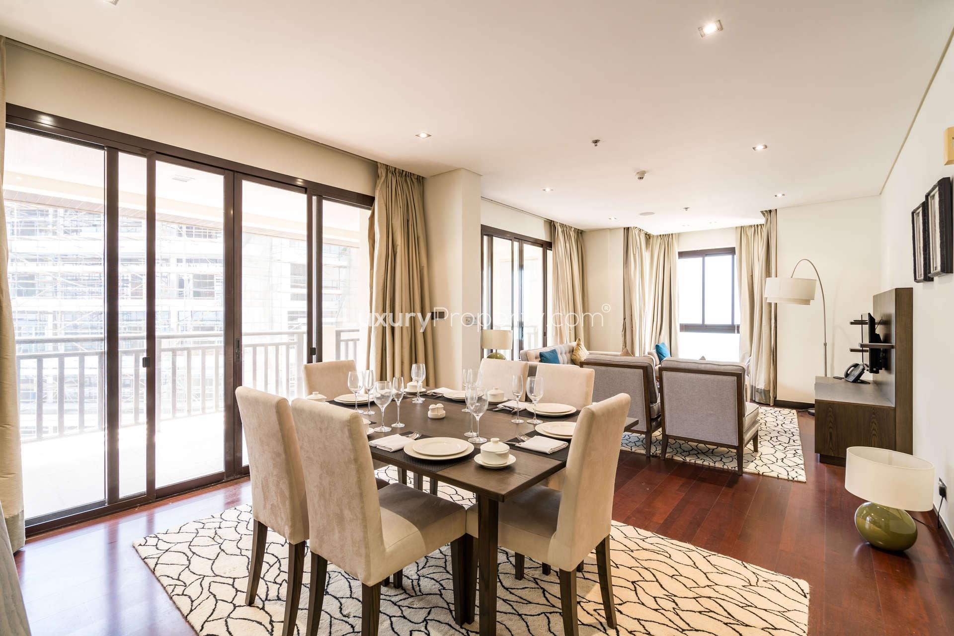 "Spacious bedroom in modern Palm Jumeirah apartment with balcony, Anantara Residences.",Modern dining and living area in two-bedroom Palm Jumeirah apartment, Anantara Residences