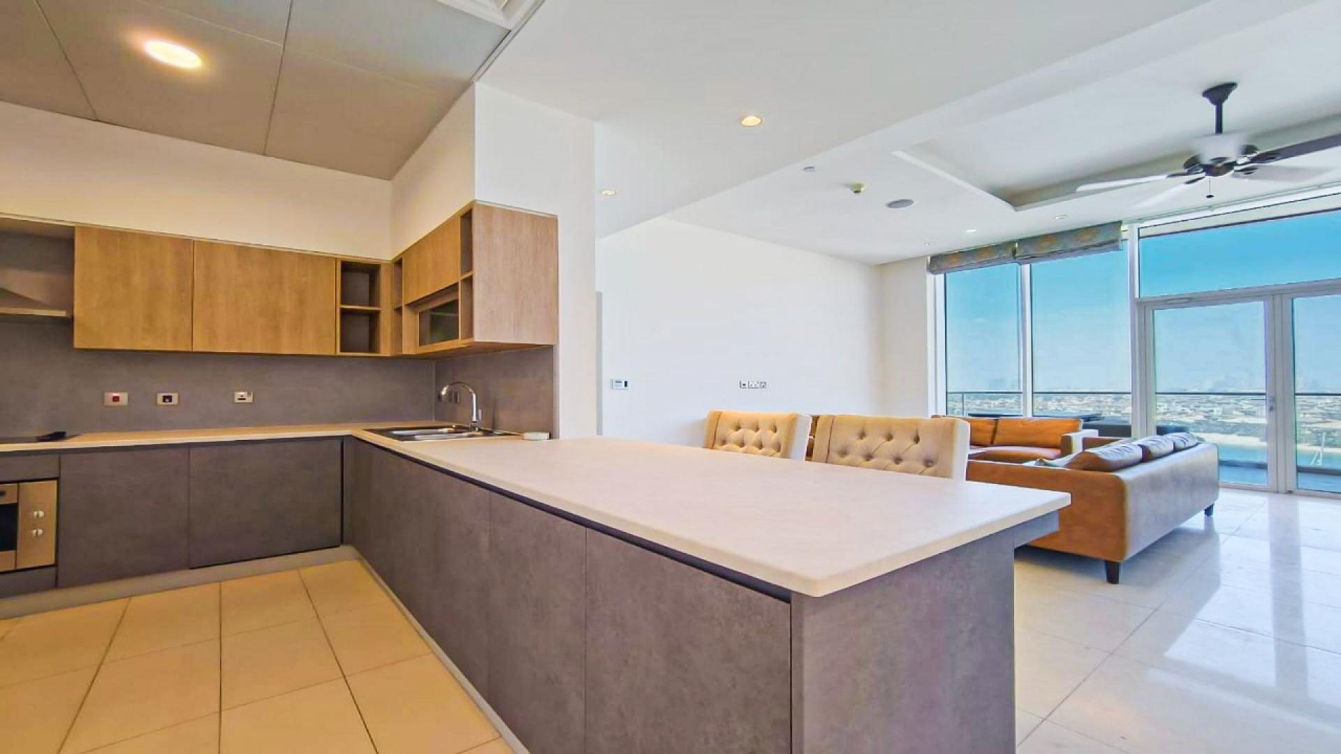 Dining area with yellow chairs in upgraded Palm Jumeirah apartment, Tiara Residences