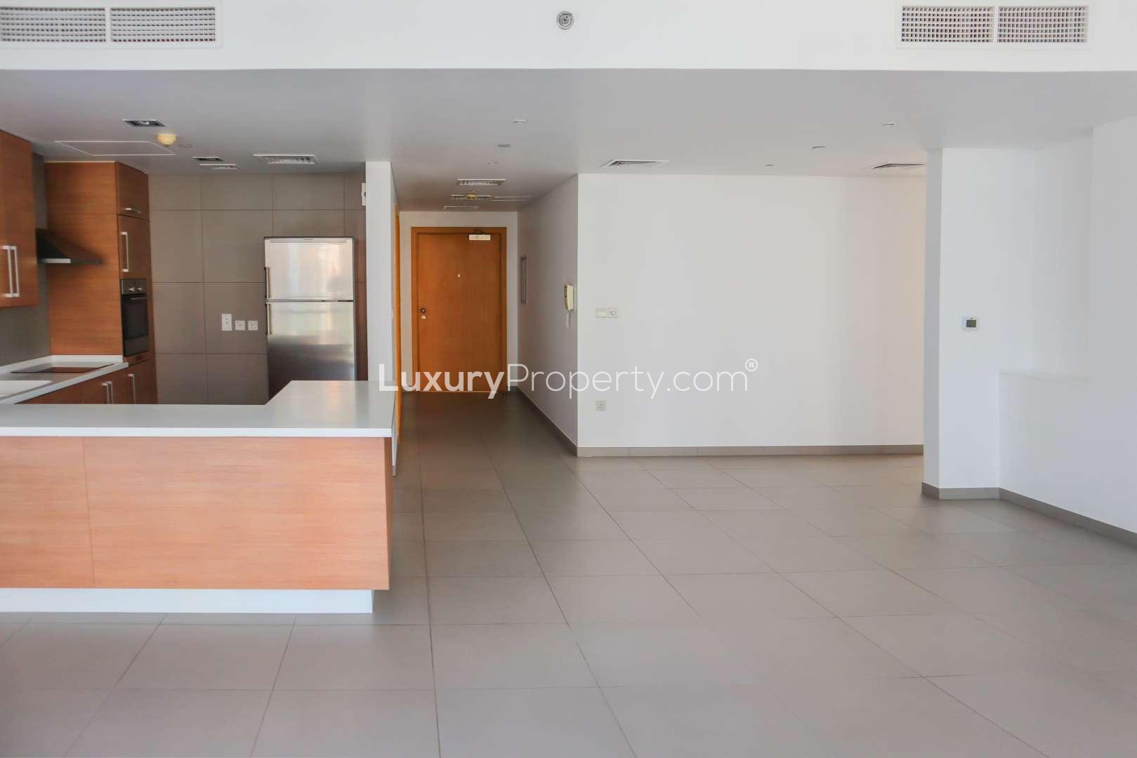 Modern kitchen in 2-bedroom apartment, Ariyana Tower, Dubai Marina, featuring sleek wood cabinetry