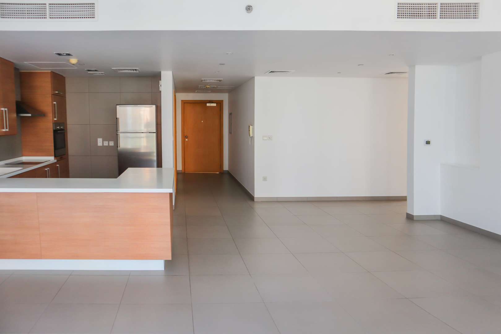 Modern kitchen in 2-bedroom apartment, Ariyana Tower, Dubai Marina, featuring sleek wood cabinetry