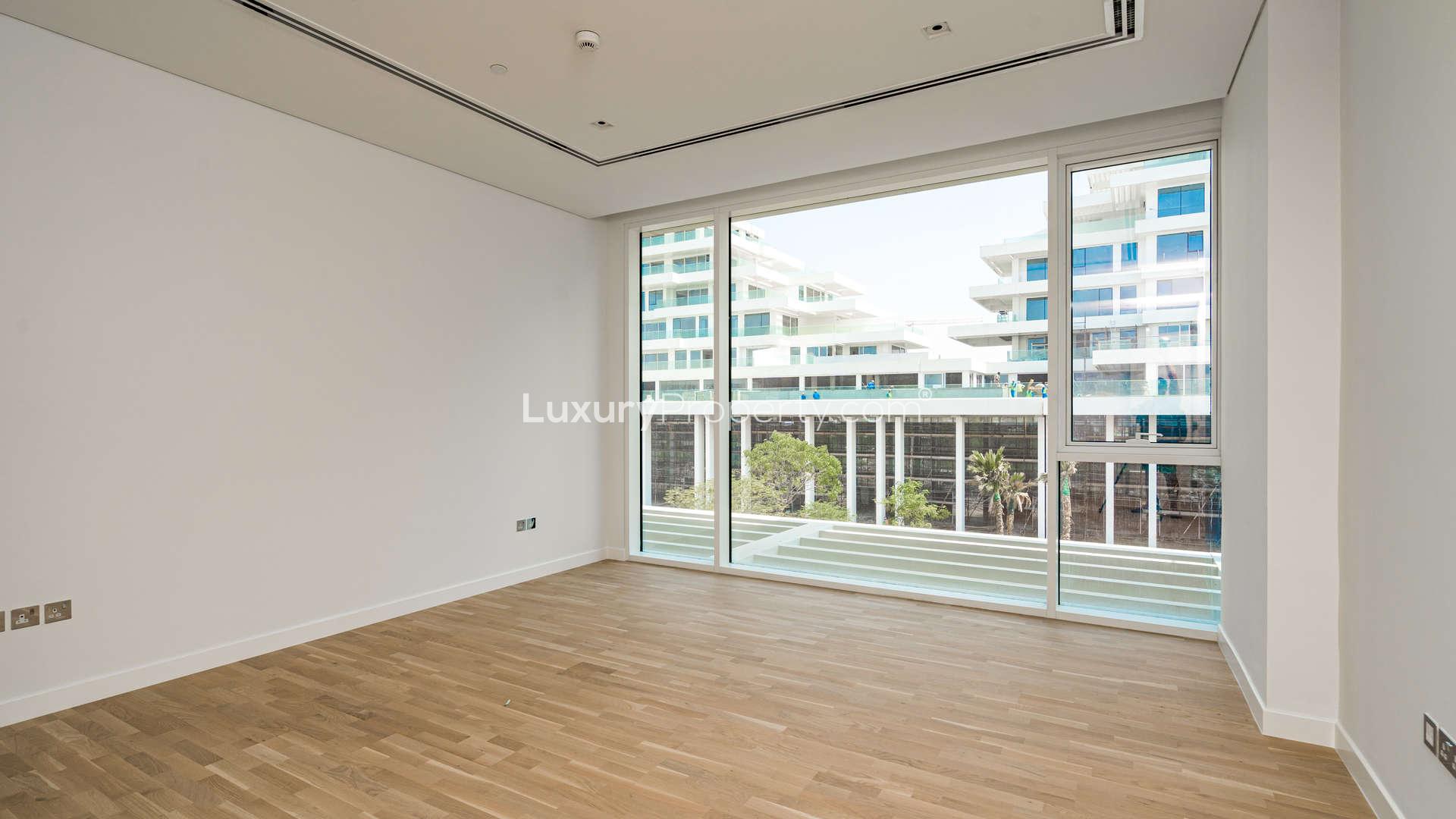 Spacious living room with large windows in Ashjar, Al Barari apartment for rent