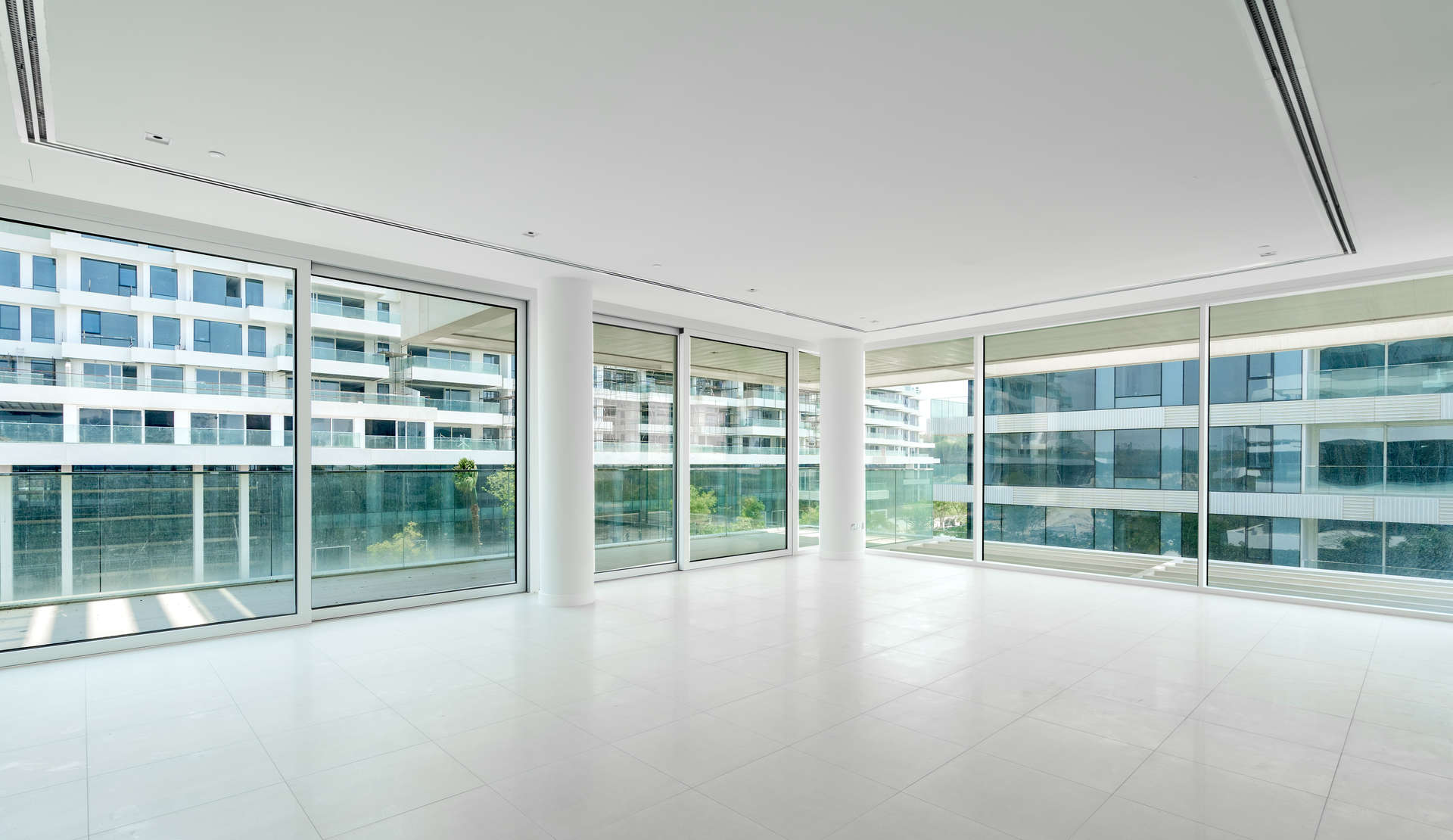 Spacious living area with floor-to-ceiling windows in Ashjar, Al Barari apartment for rent