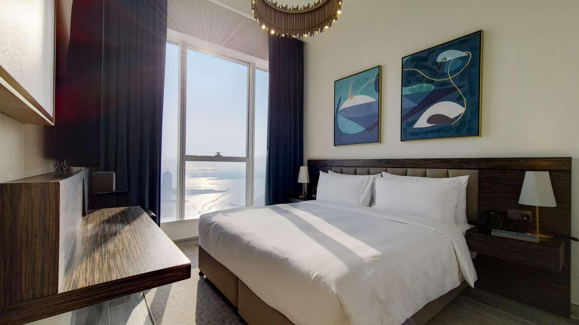 Luxurious bedroom with sea view in Avani Palm View, Dubai Media City apartment