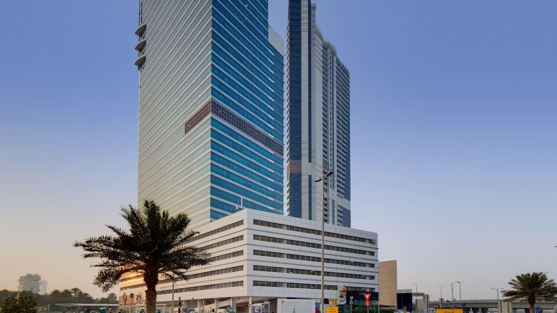 "Luxurious Dubai Media City apartment living room with sea view, modern decor, and elegant furnishings.",Exterior view of Avani Palm View Hotel & Suites in Dubai Media City