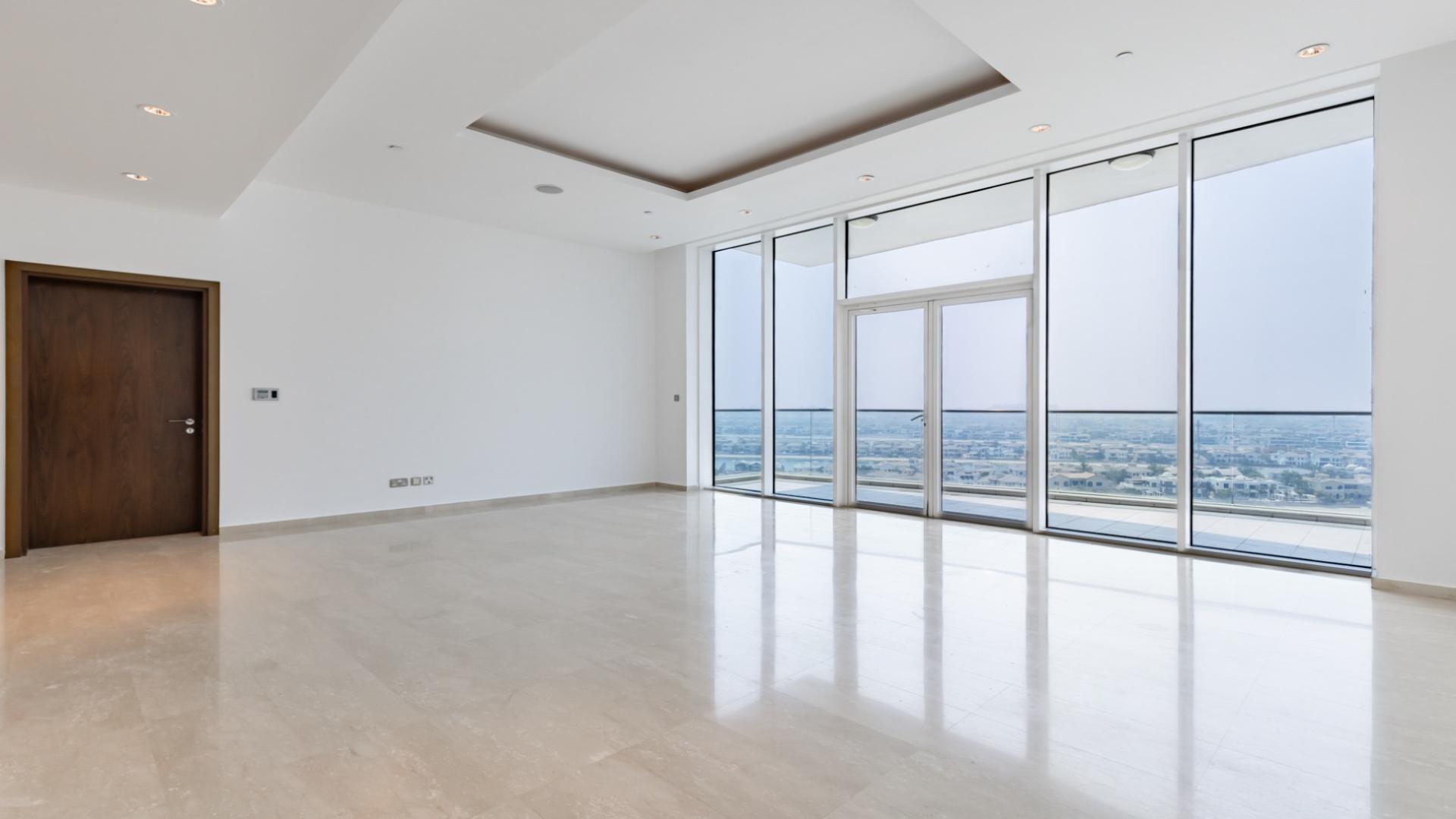 Spacious Palm Jumeirah apartment living area with large windows and modern kitchen