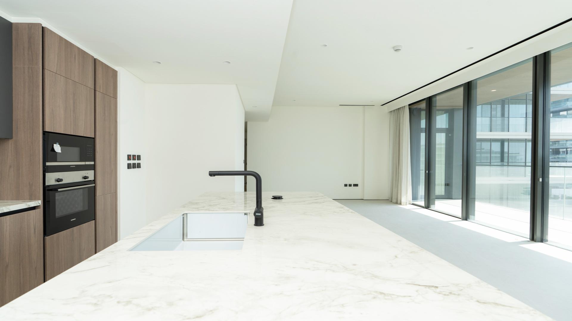 Modern kitchen with marble island in Dubai Hills Estate apartment, Park Lane, available for rent