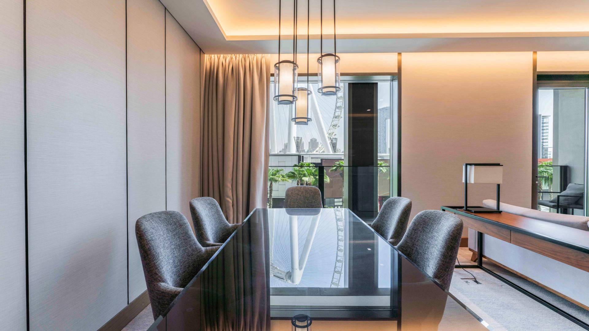 Modern kitchen and living area in Bluewaters apartment, featuring sleek design and natural light