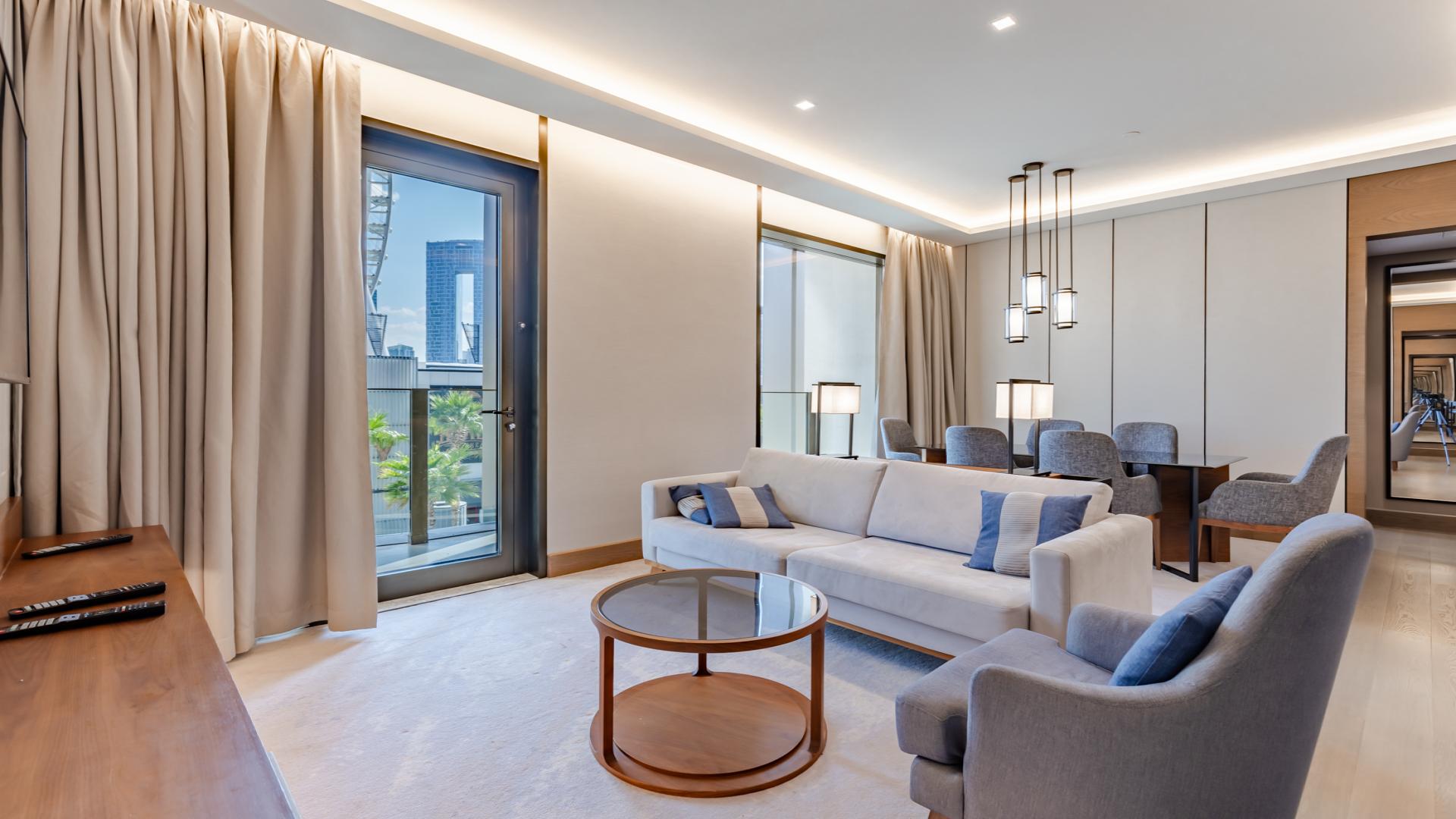Modern living room in Bluewaters Dubai apartment with elegant furnishings and open kitchen