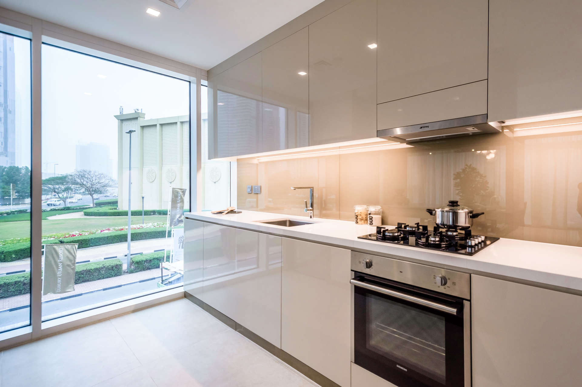 Modern kitchen with sleek design in high-floor Jumeirah Lake Towers apartment, Emirates Hills view