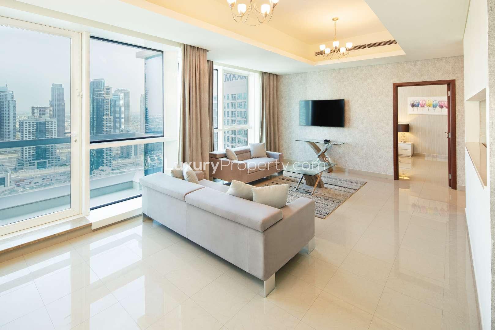 Two-bedroom apartment interior with twin beds, modern decor, and marina view window in Dubai Marina