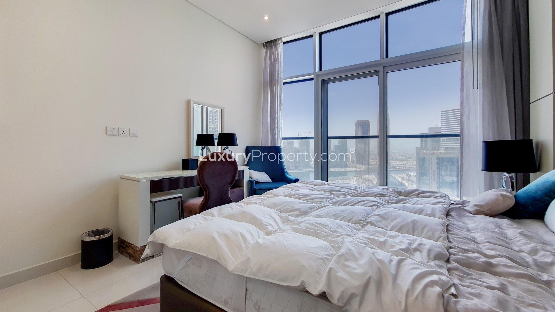 Modern kitchen with sleek black cabinets in Bay's Edge apartment, Business Bay for rent