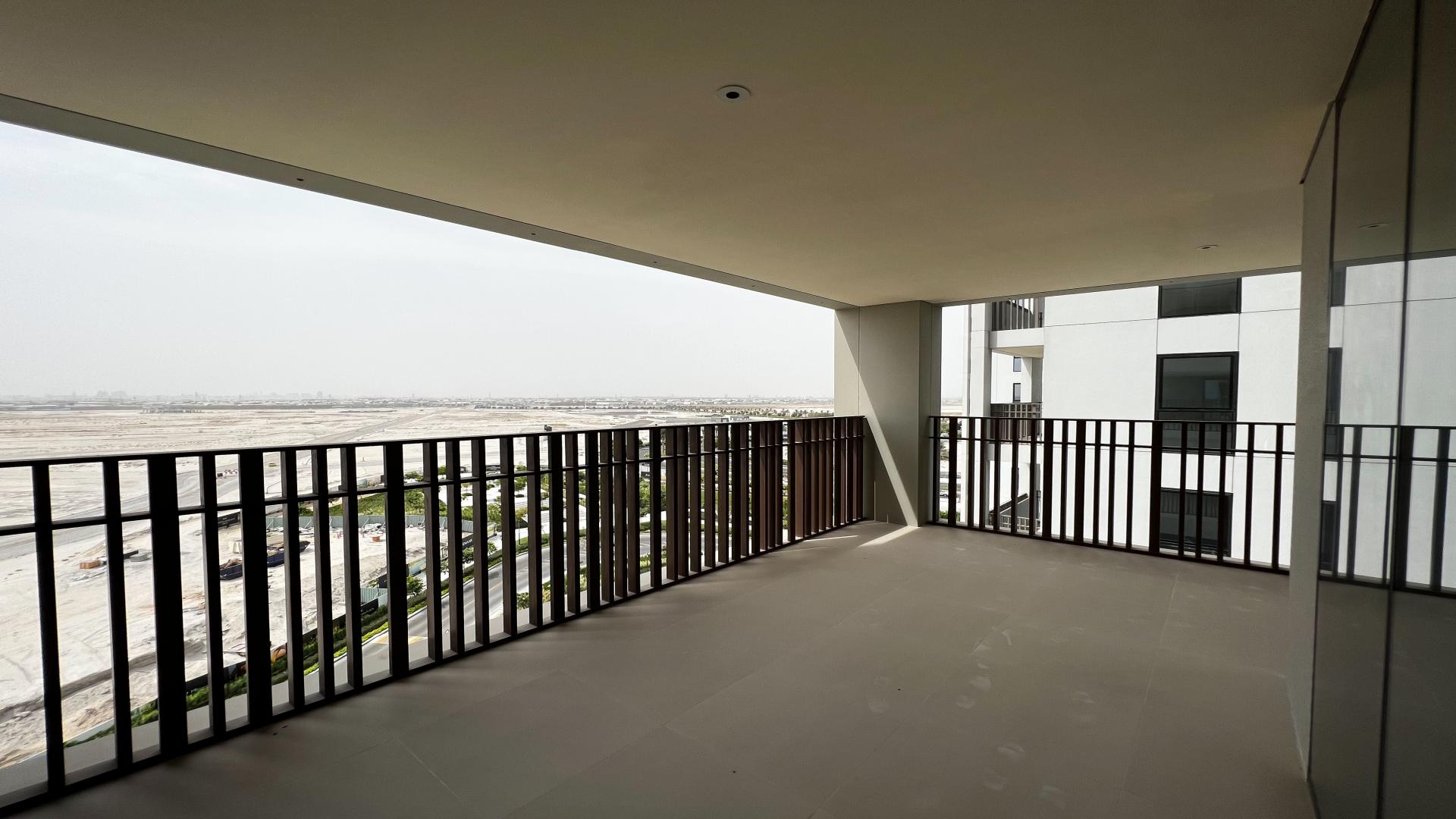 Luxury apartment pool area in Bayshore, Dubai Creek Harbour with sun loungers and umbrellas