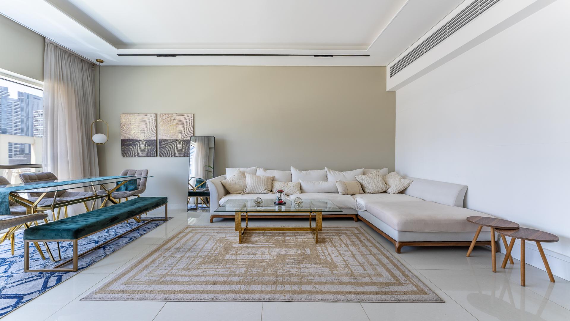 Modern living room in Business Bay apartment, featuring city views and elegant decor