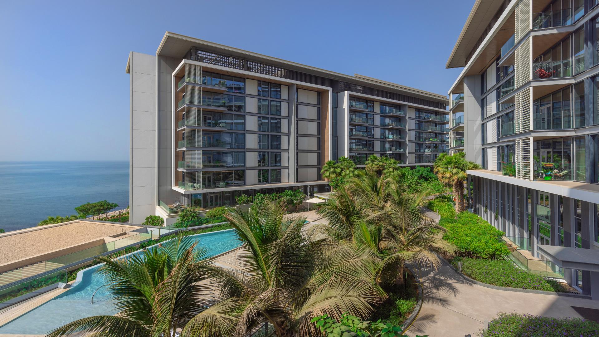 Spacious Bluewaters apartment living room with sea views, hardwood floors, and large windows