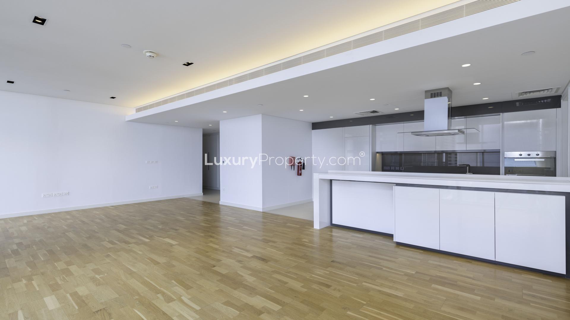 Contemporary apartment balcony with sea views and lush greenery in Bluewaters Residences