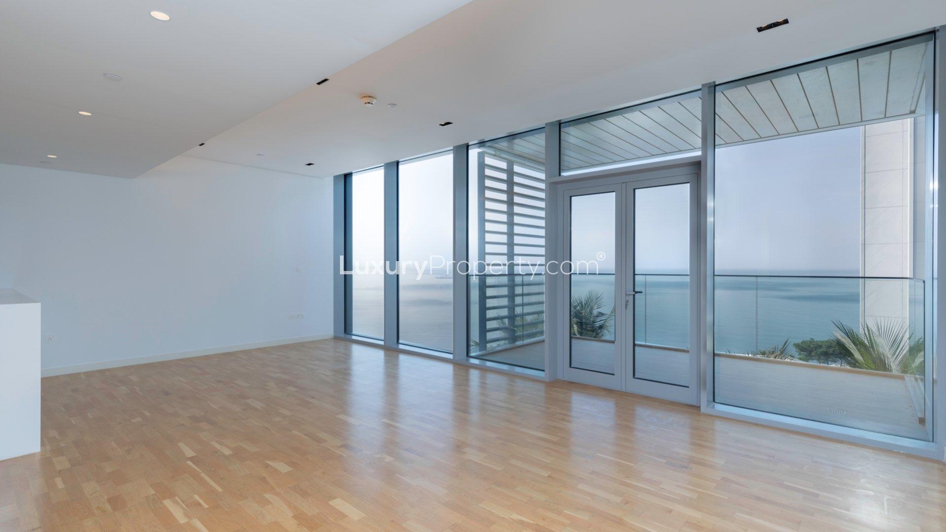 Contemporary Bluewaters apartment balcony with panoramic sea views, glass railing, and modern design