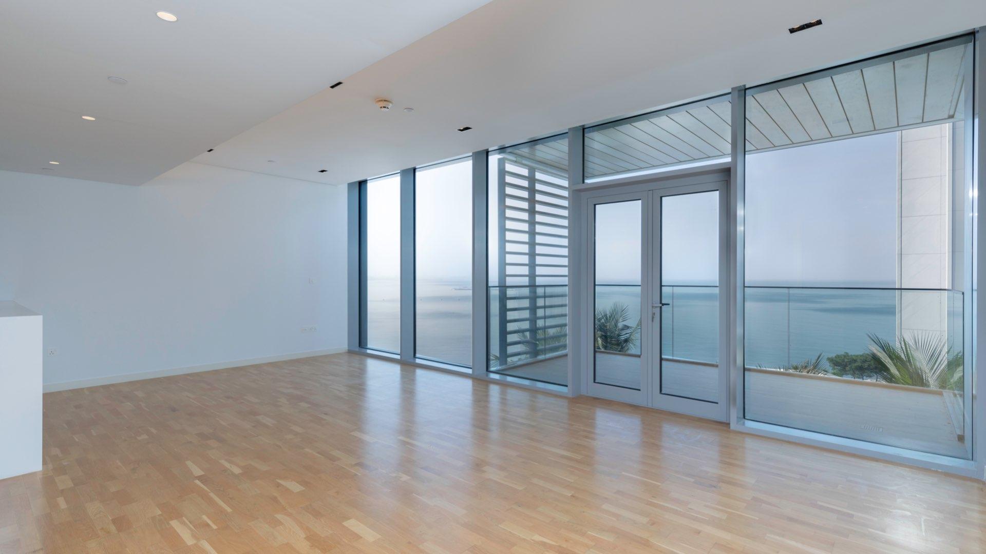 Contemporary Bluewaters apartment balcony with panoramic sea views, glass railing, and modern design
