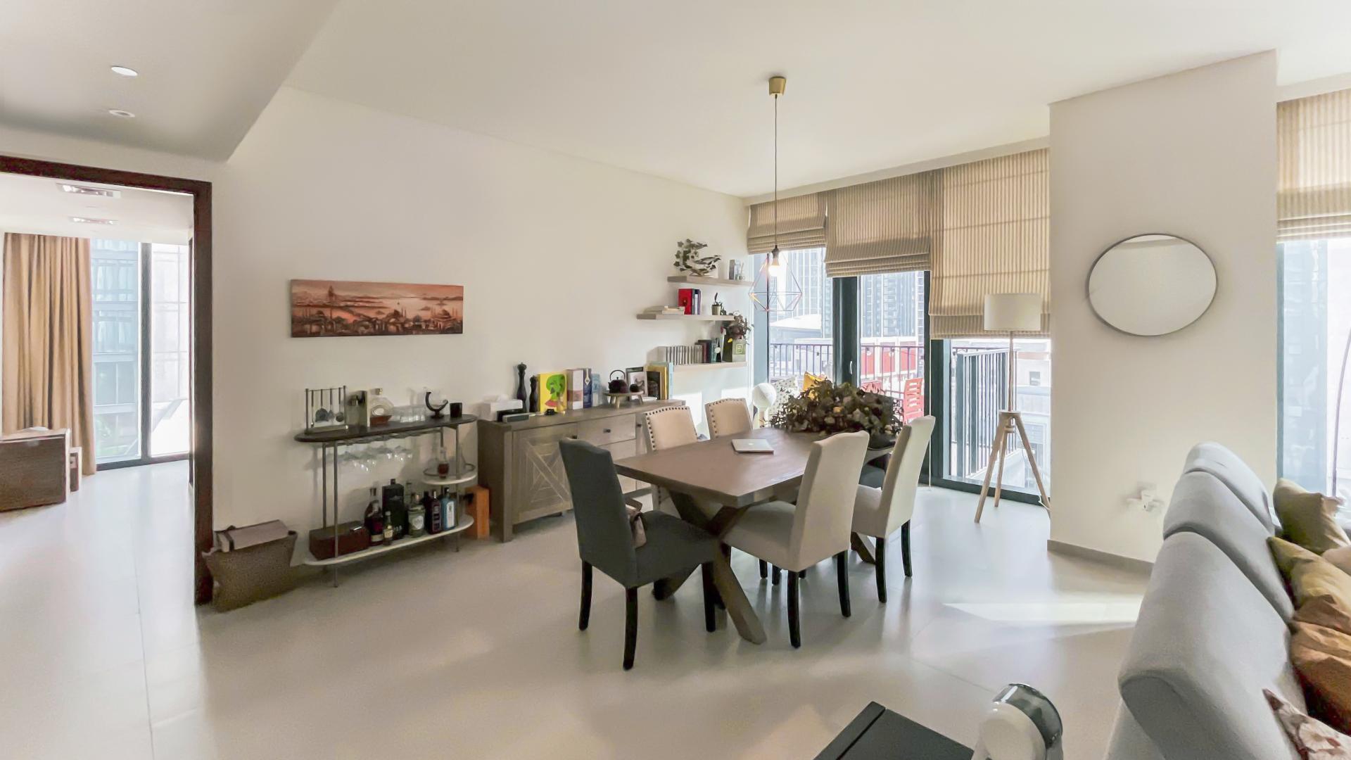 "Downtown Dubai skyline view from BLVD Heights apartment, featuring modern high-rise buildings and boulevard.",Dining area in 2-bedroom corner unit, BLVD Heights, Downtown Dubai, with city views