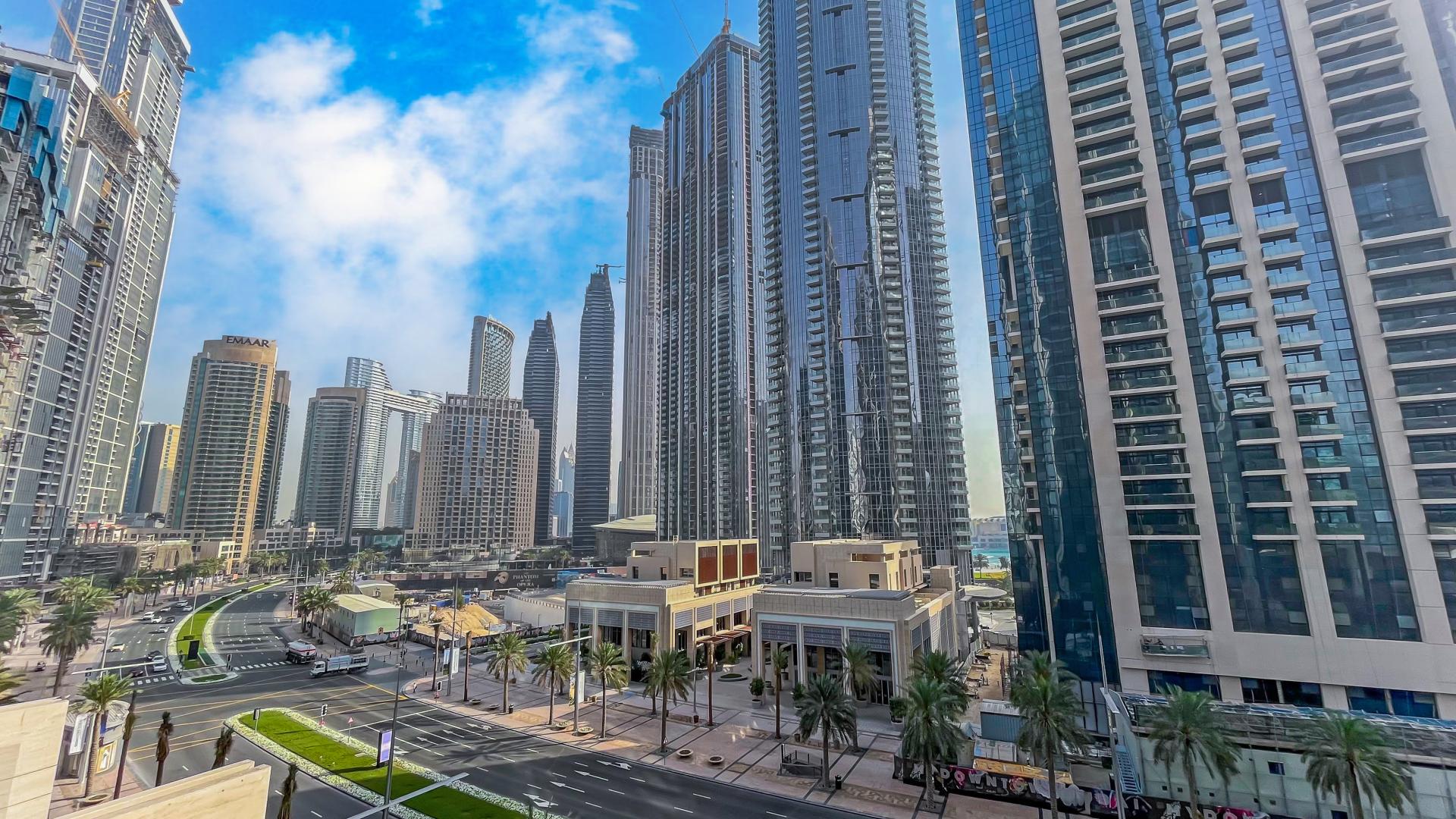 Modern living room in 2-bedroom apartment, BLVD Heights, Downtown Dubai. Cozy decor, open kitchen