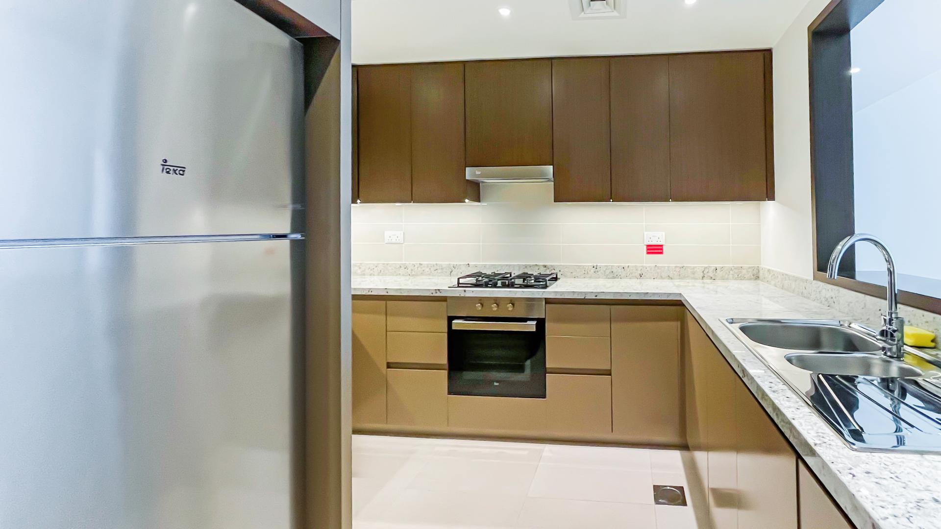 Modern kitchen in BLVD Heights apartment, Downtown Dubai, with sleek cabinets and stainless steel appliances