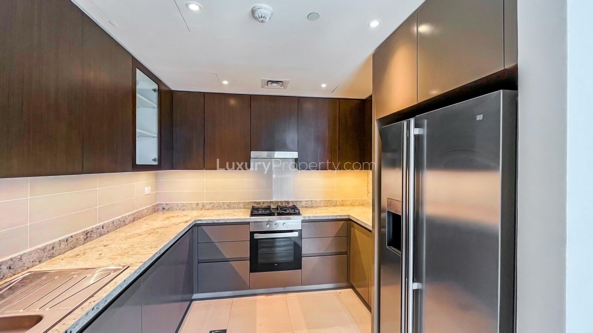 Modern kitchen in 2-bedroom apartment, BLVD Heights, Downtown Dubai, featuring sleek cabinetry and appliances