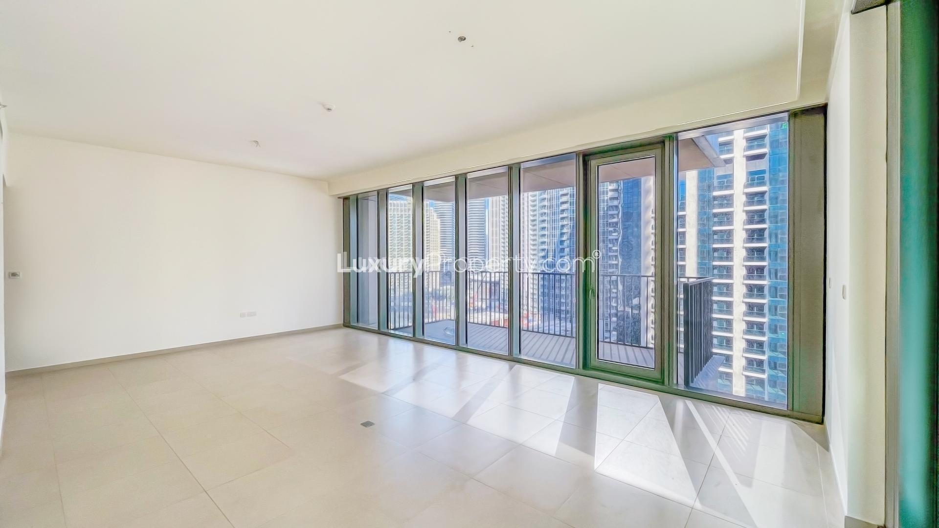 Bright living room with floor-to-ceiling windows in Downtown Dubai apartment, scenic city views