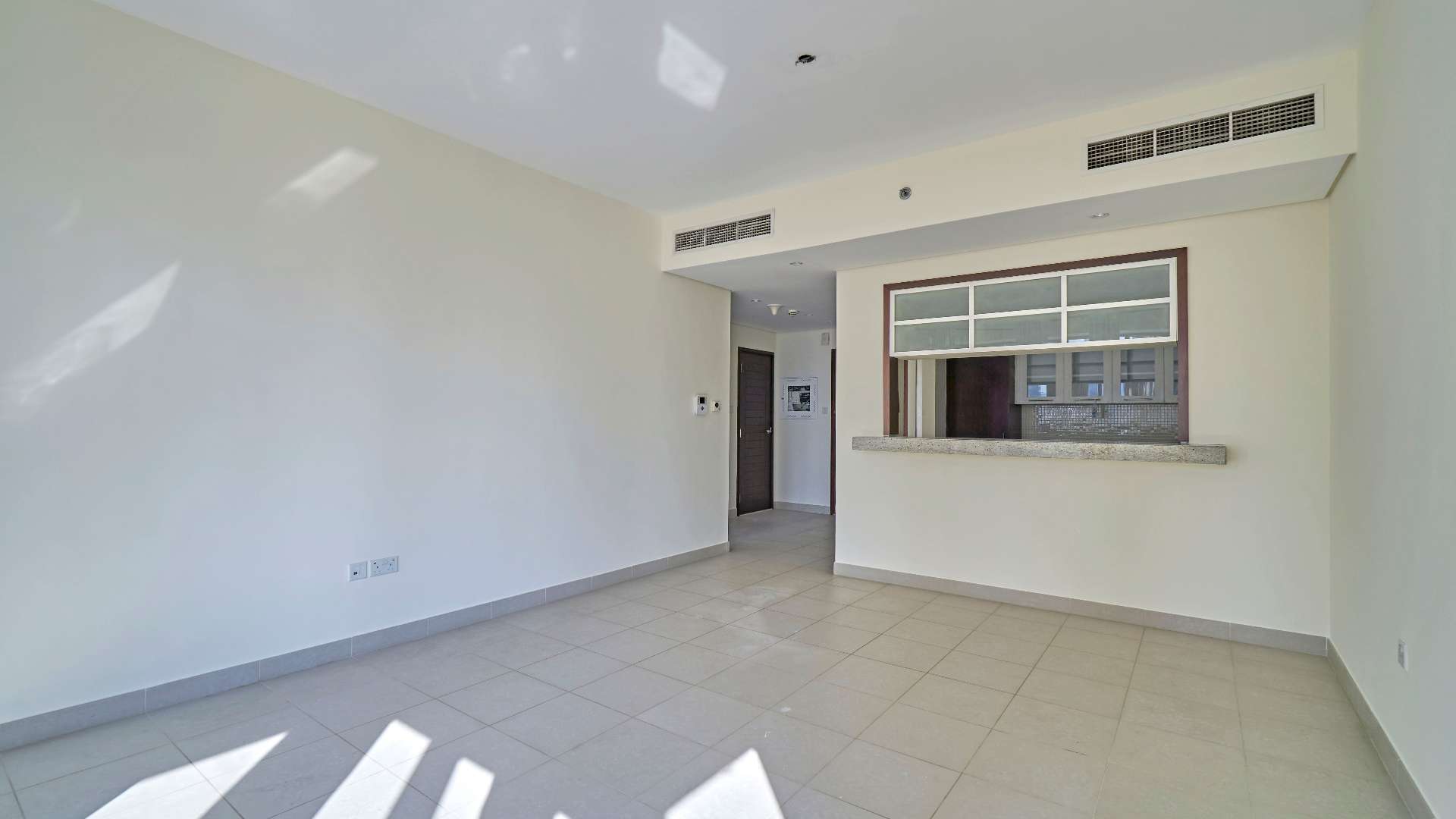 Modern apartment living room with large windows and city view in Downtown Dubai