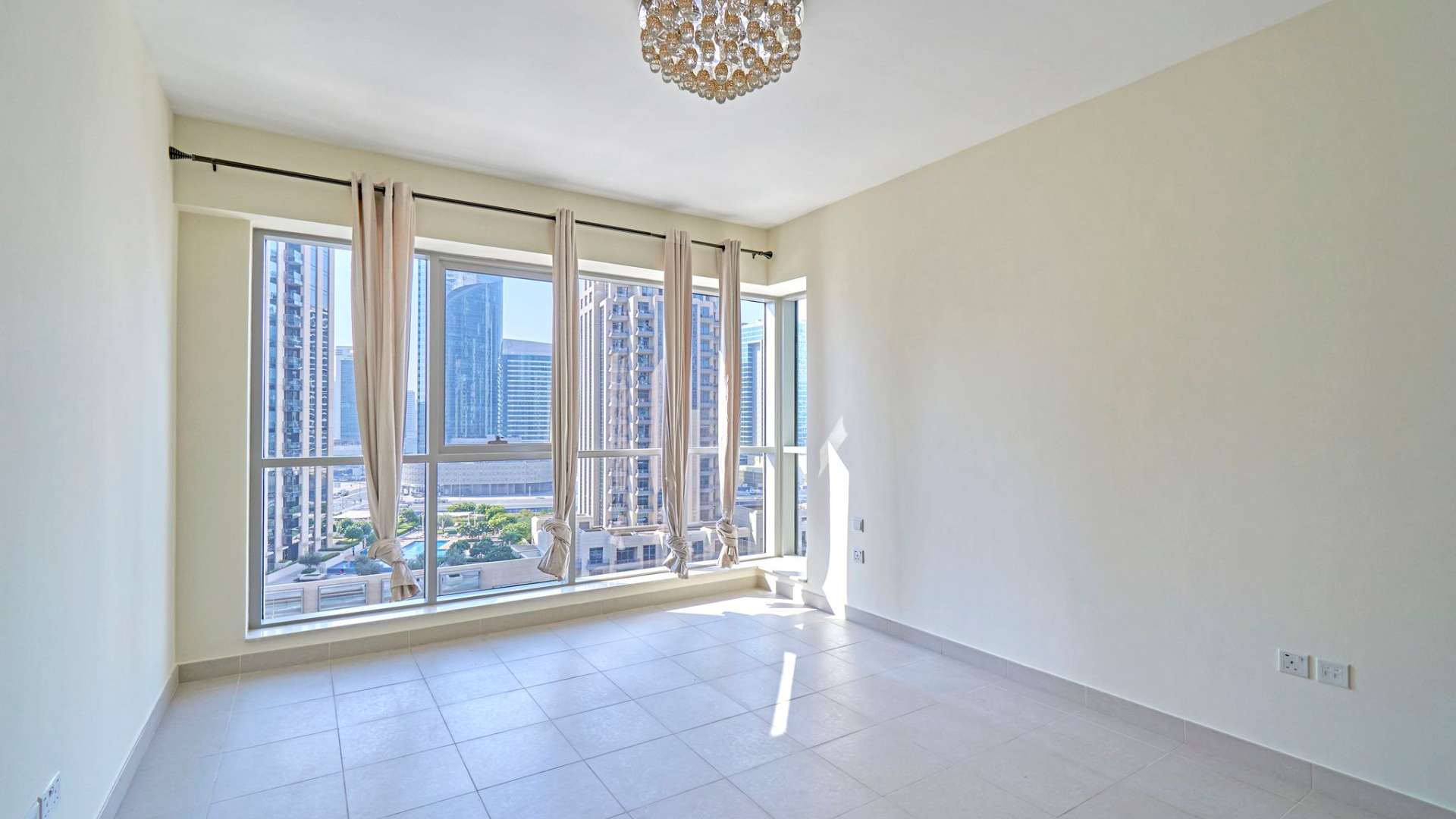 "Spacious living area in modern 2-bedroom Downtown Dubai apartment, Boulevard Central Towers.",Modern Downtown Dubai apartment with large windows, bright interior, and city view at Boulevard Central