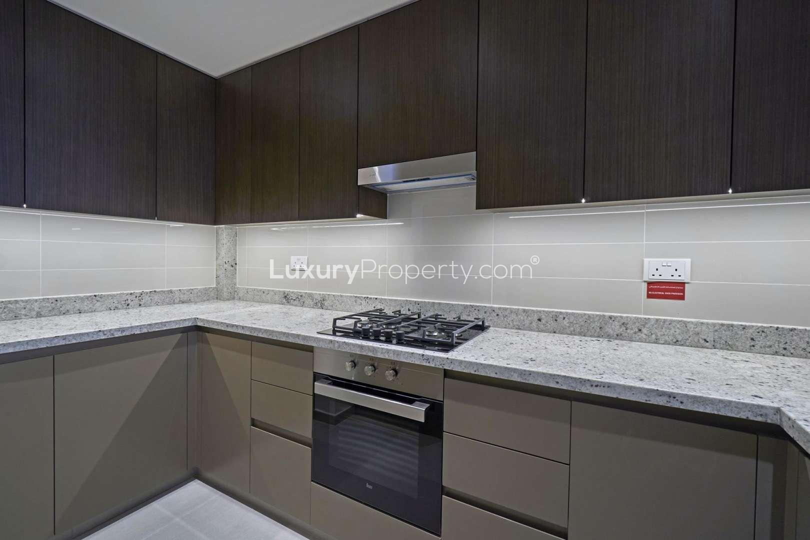Modern kitchen in 2-bedroom apartment, BLVD Heights, Downtown Dubai, featuring sleek countertops