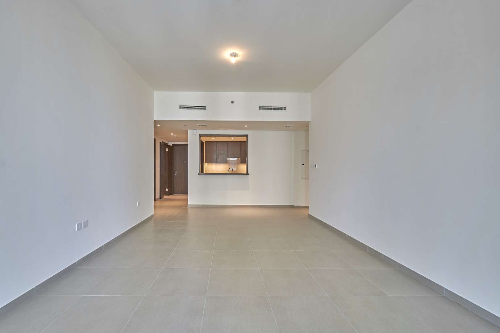 Empty living room in two-bedroom apartment, Boulevard Heights, Downtown Dubai, for rent