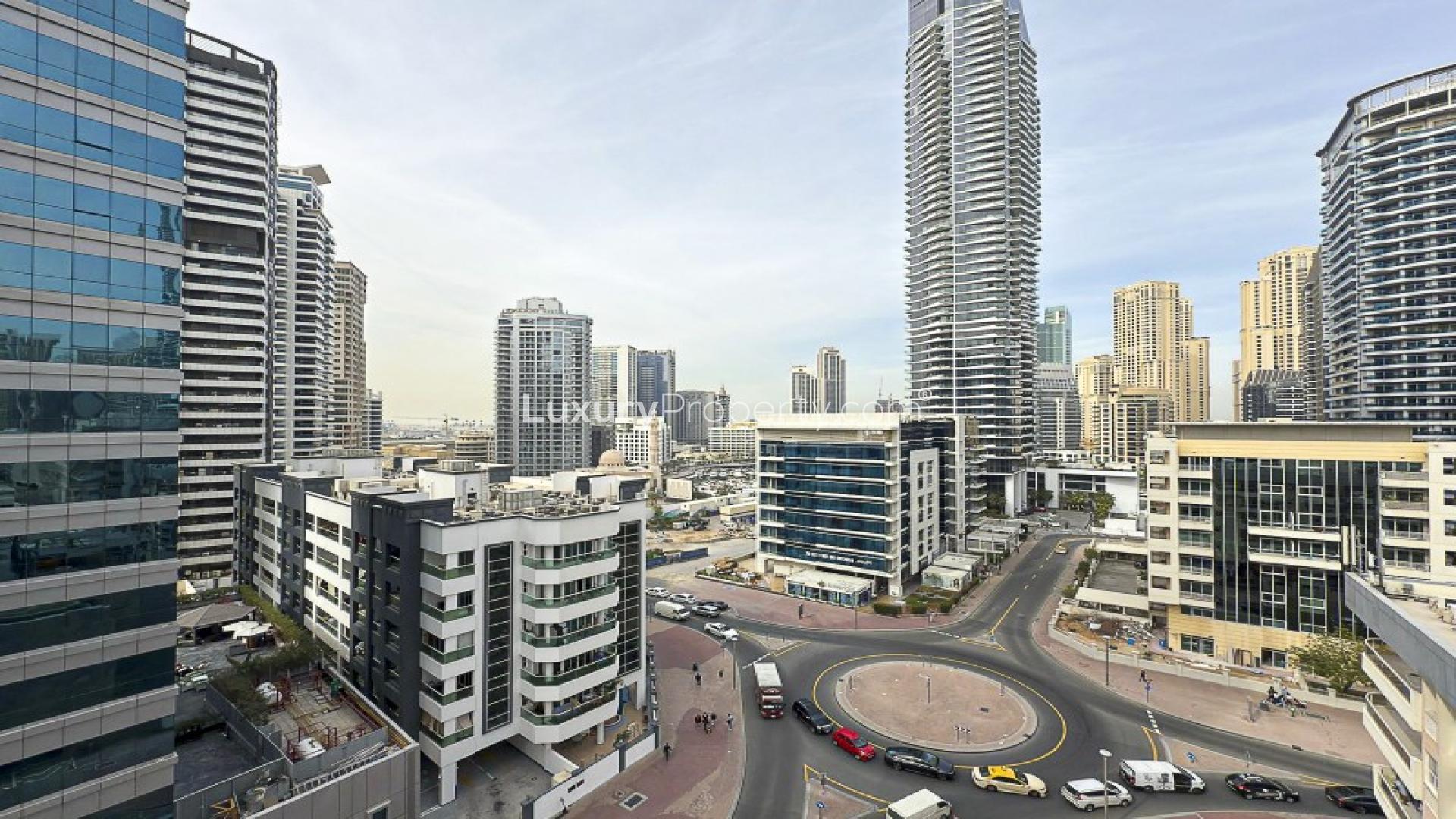 Modern kitchen and living area with city view in Marina Living apartment, Dubai Marina