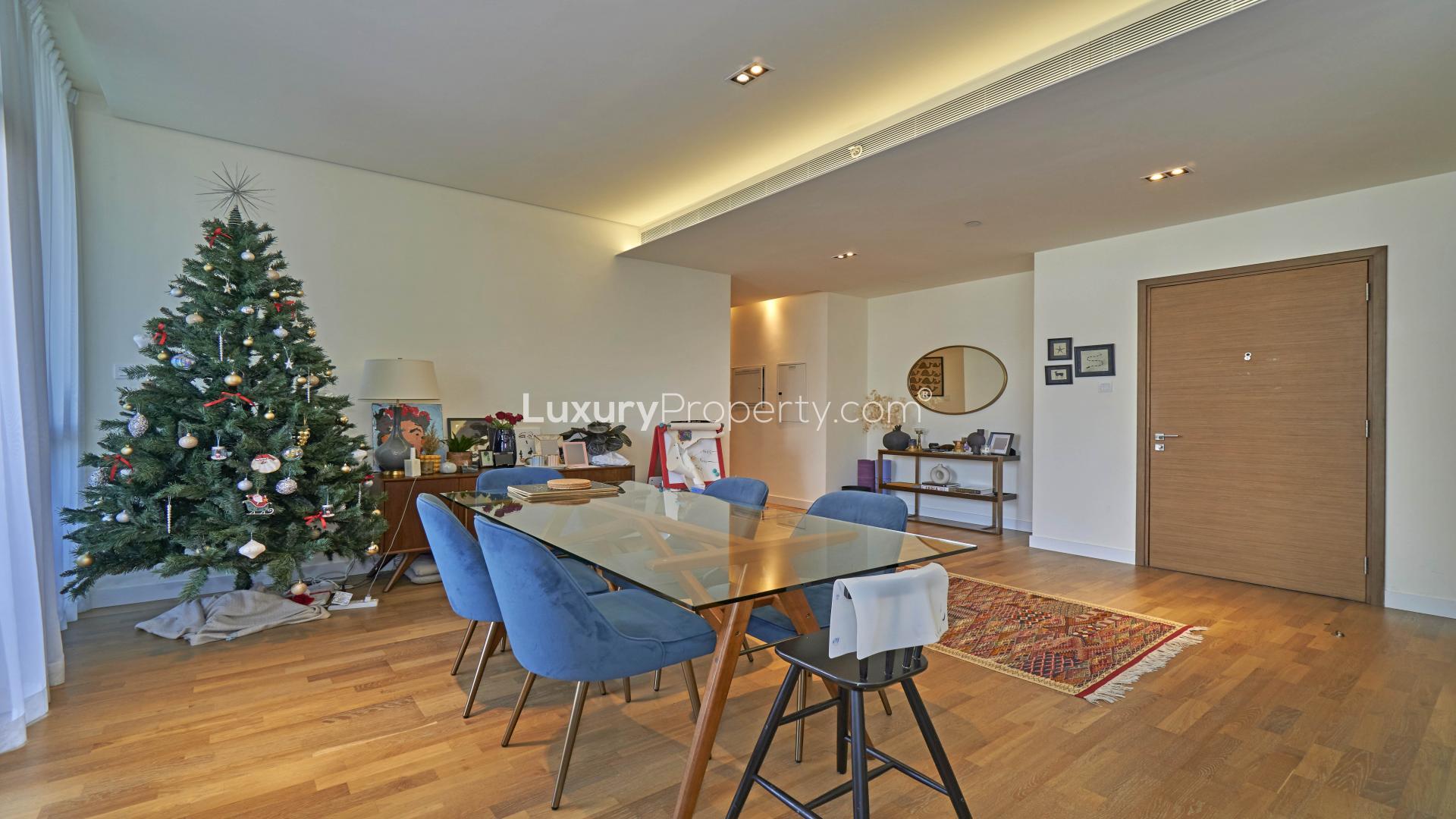 Spacious living room in two-bedroom City Walk apartment with large windows and modern decor
