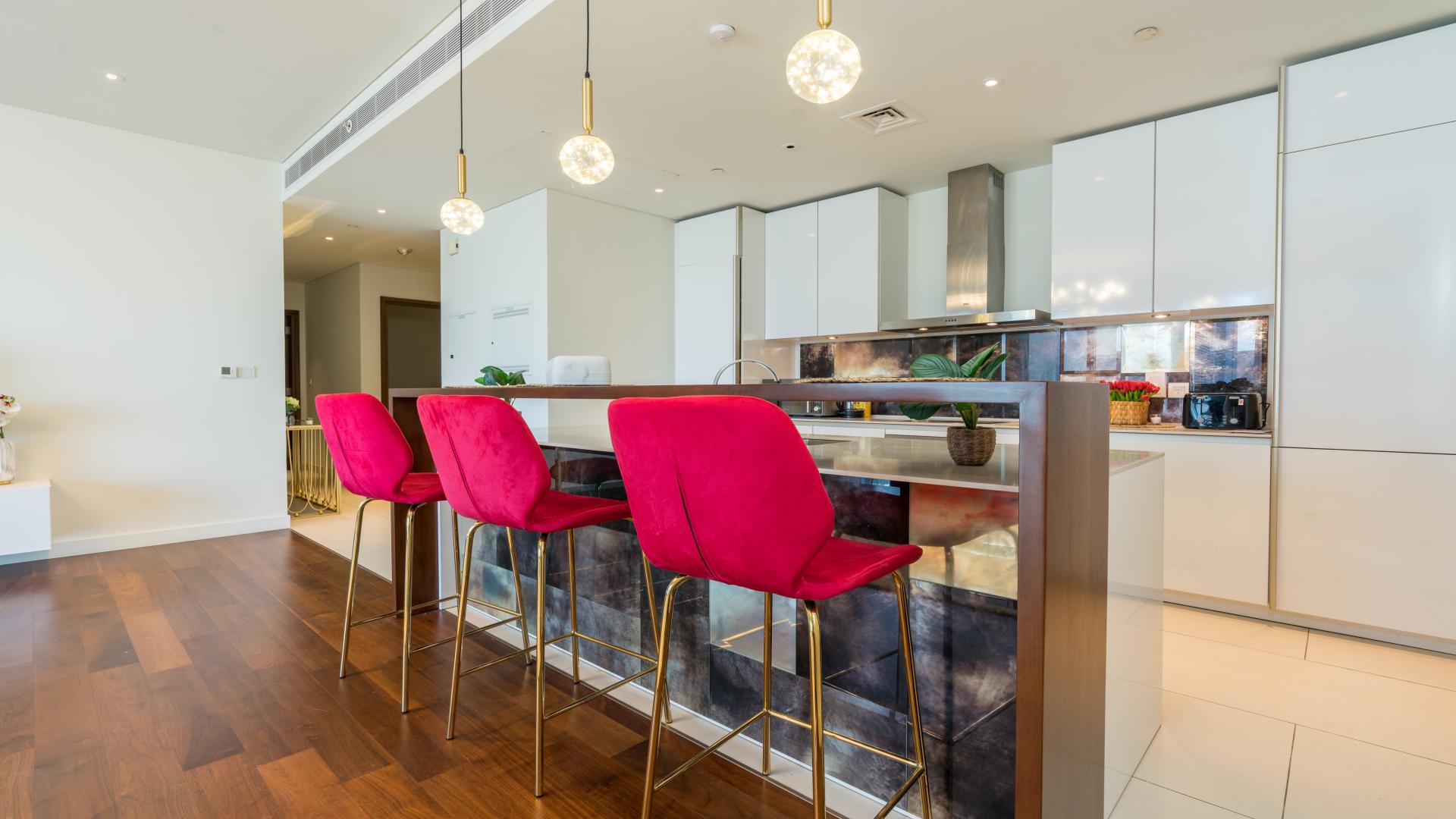 Spacious living room with modern decor in City Walk apartment, hardwood floors, large windows