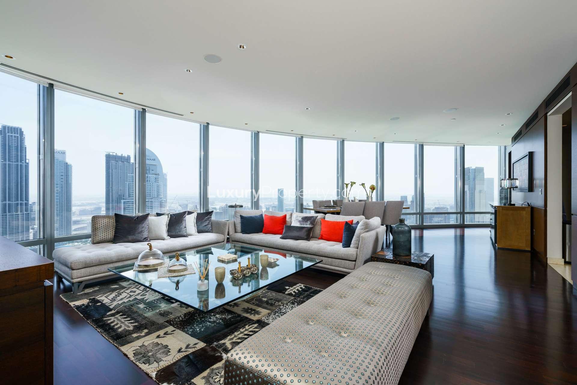 Furnished apartment living room with floor-to-ceiling windows and stunning Downtown Dubai views