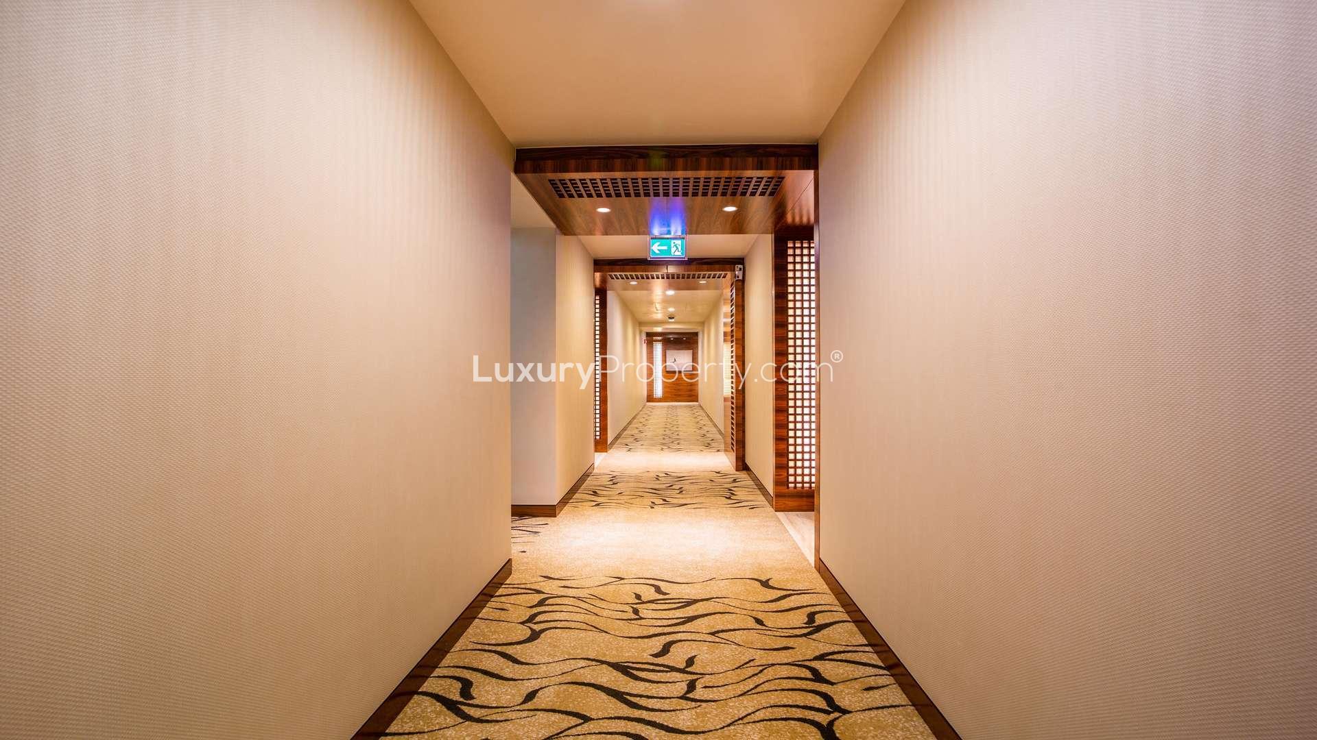 Alt text: "View of Burj Khalifa, luxury apartment for rent in Downtown Dubai, LP03963.","Elegant hallway in Burj Khalifa apartment for rent, Downtown Dubai, two-bedroom property.",Luxurious living room with panoramic city views in Burj Khalifa apartment, Downtown Dubai