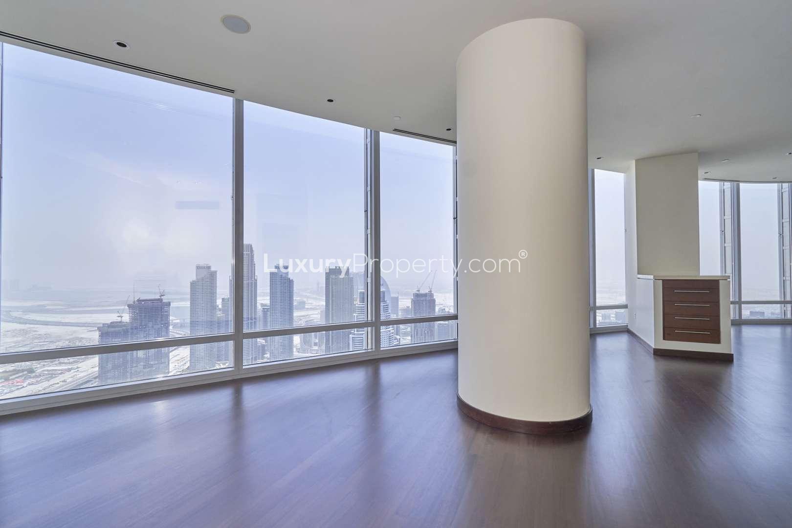 Stunning Burj Khalifa apartment interior with panoramic windows and hardwood floors in Downtown Dubai