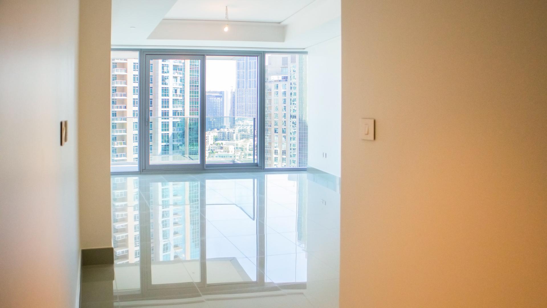 Modern kitchen in Opera Grand apartment, Downtown Dubai, featuring sleek cabinets and stainless steel appliances