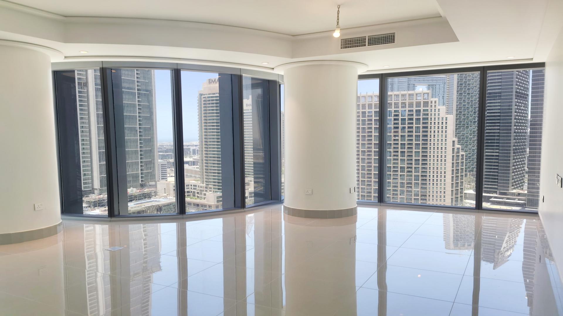 Luxury apartment interior with floor-to-ceiling windows, downtown Dubai skyline views